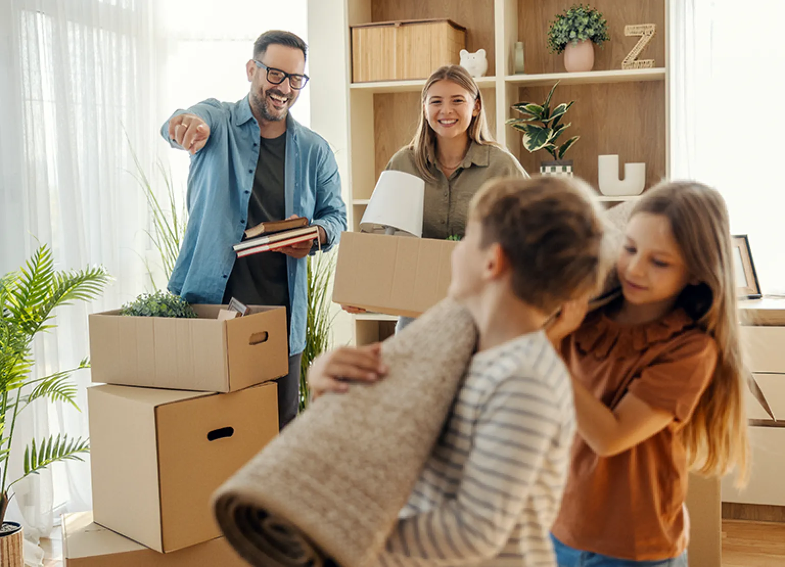 Family unpacking boxes in a new home