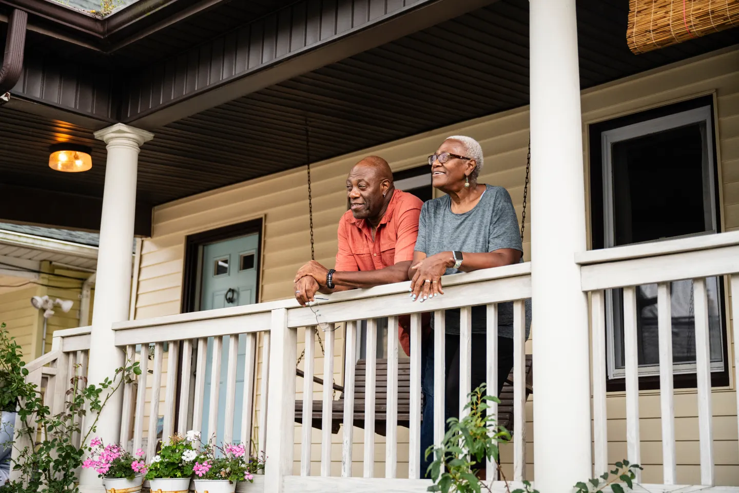 Homeowners standing outside their home